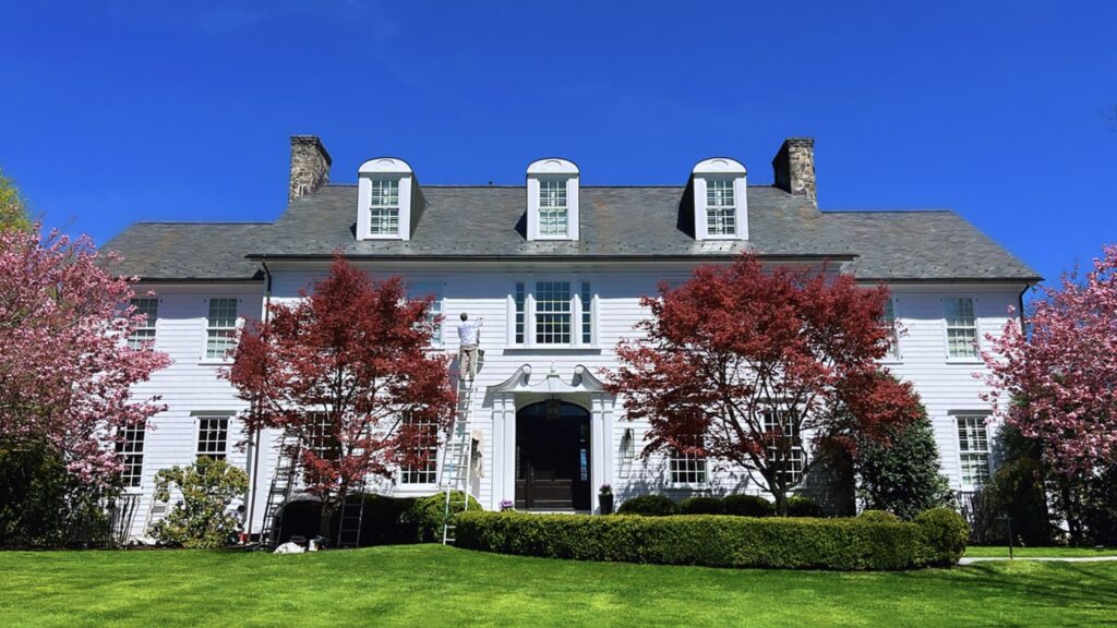 Exterior repainting project in Darien CT with white siding and bright curb appeal