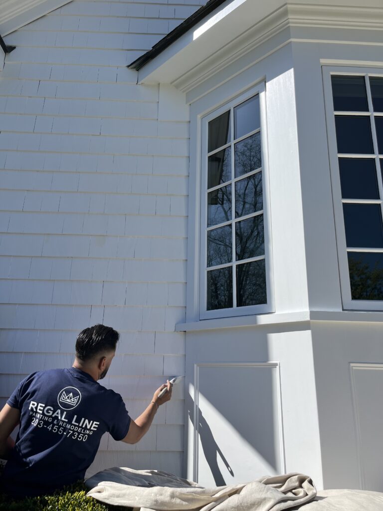 Exterior painting project in Darien CT with fresh white trim and detailed siding finish