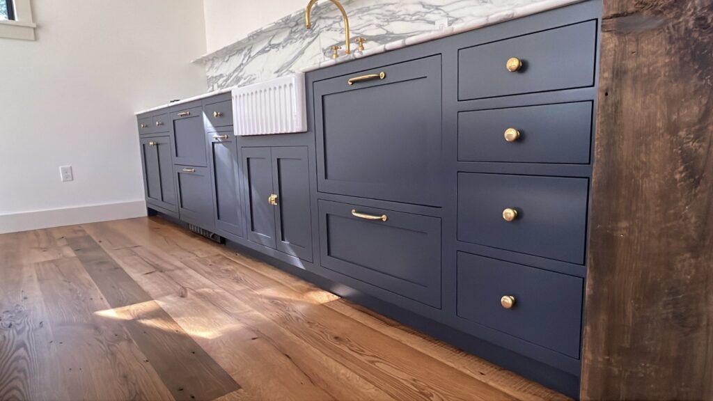 Cabinet painting project in Pound Ridge NY with navy custom cabinetry and brass hardware