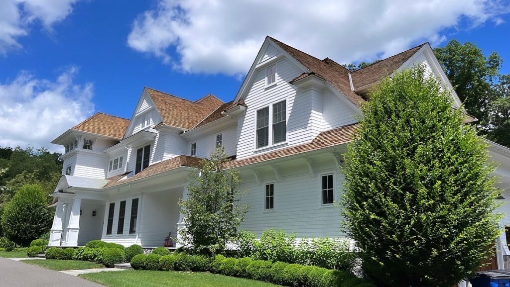Exterior repainting project in Westport CT with bright white siding and clean transitions