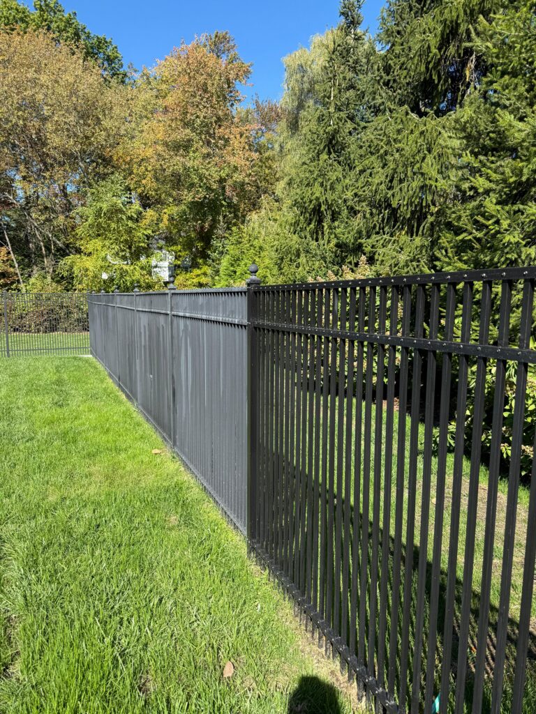 Fence revitalization project in Scarsdale NY with refreshed black metal fencing